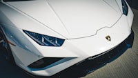 the front end of a white lamborghini sports car